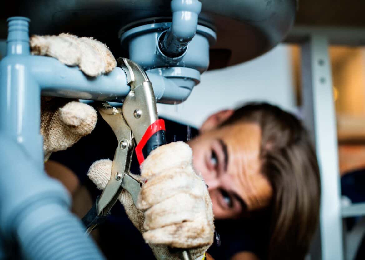Plumber Fixing Kitchen Sink Leak Ly